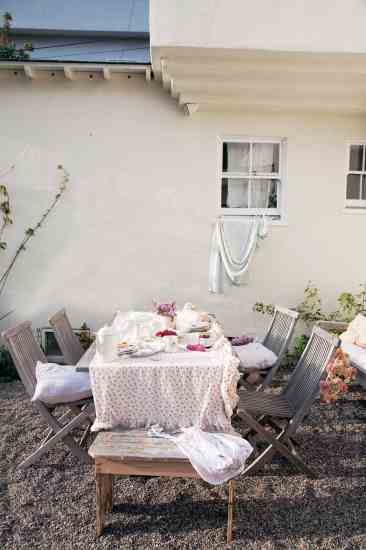 The ruffled rose-covered tablecloth is an old curtain that has been following Ashwell around for years.